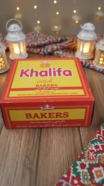 Festive Khalifa Bakers box wrapped in lanterns and ajrak — perfect for gifting